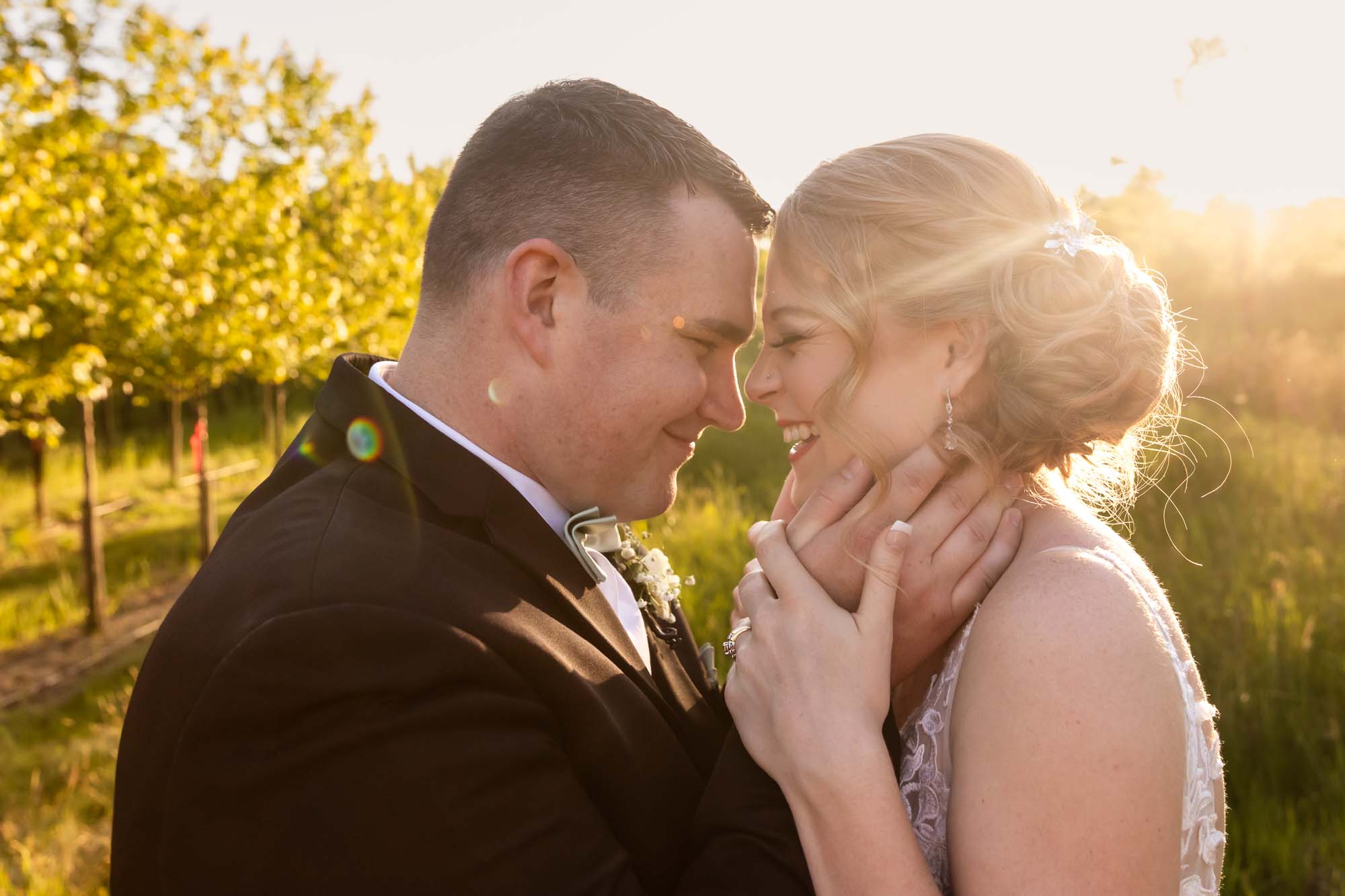 close up picture of bride and groom snuggling together at sunset in beautiful light at pinehall at eisler farms